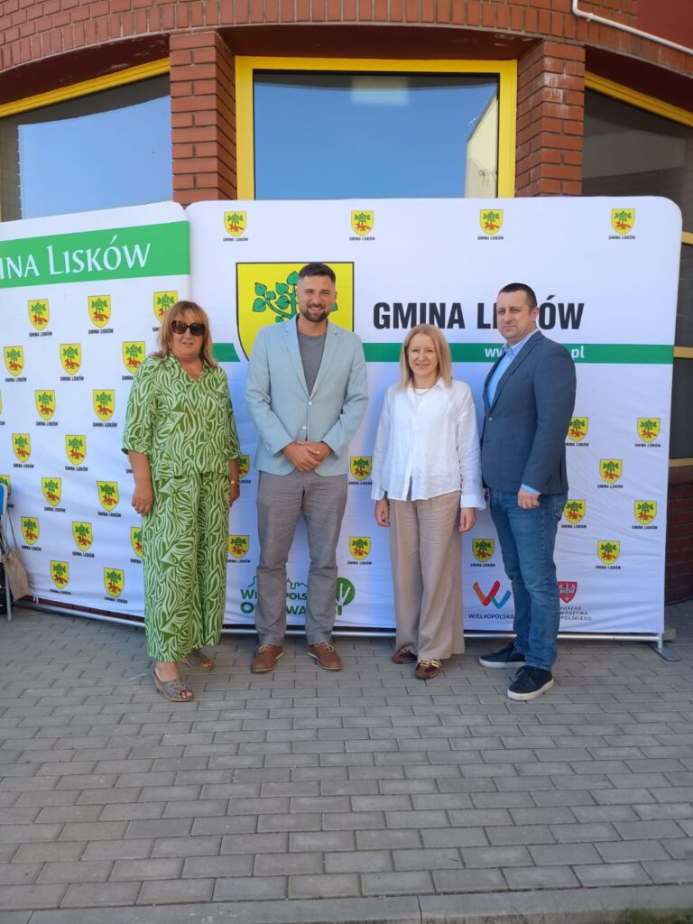 Zaproszeni goście na tle ścianki gminy Lisków - zdjęcie grupowe